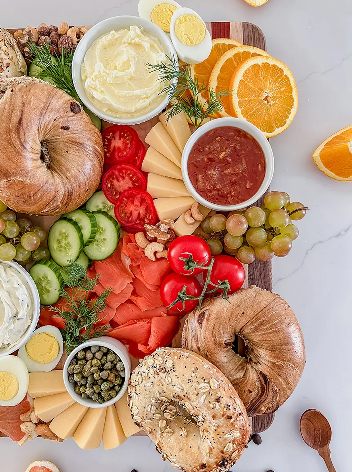 harry and david's bagel charcuterie board idea with fresh bagels, cheese, eggs, and more.