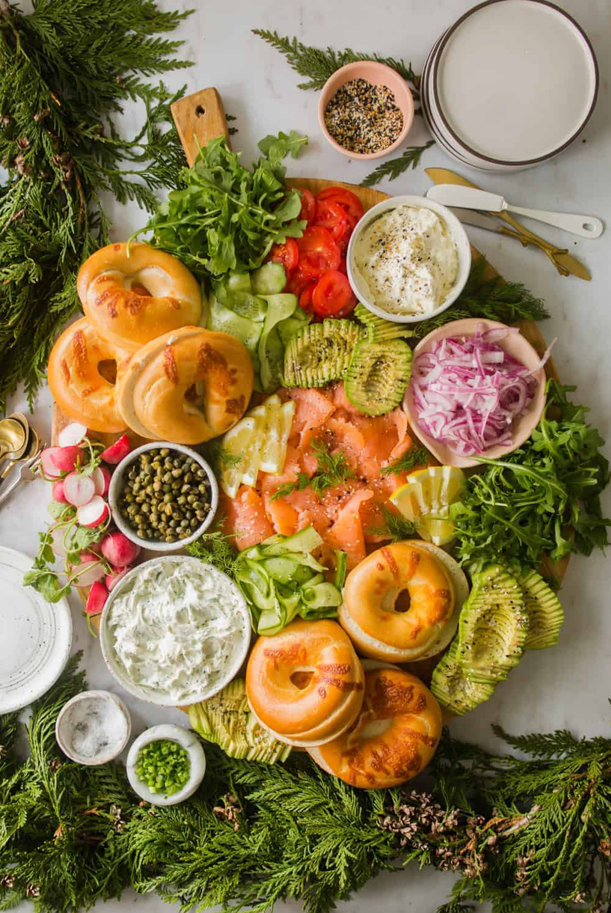 lena's kitchen blog bagel charcuterie board with lox, thin cucumbers, onion, and cream cheese options.