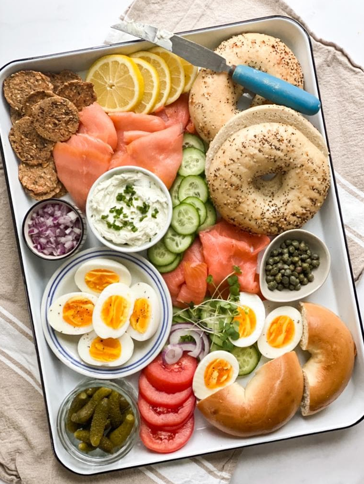 The family food kitchen created a simple board with bagels, cucumbers, hard boiled eggs, and capers.