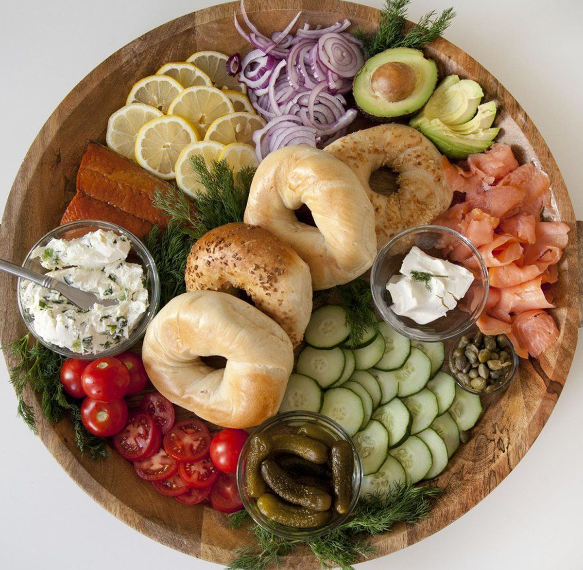 urban cookery includes a variety of bagels, spreads, and toppings like onion, avocado, salmon, and more.