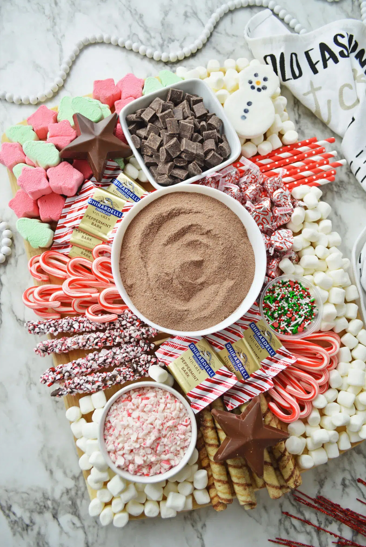 chocolate stars, marshmallow snowman, and peppermint bread sticks are all a part of this board from making mom magic. 