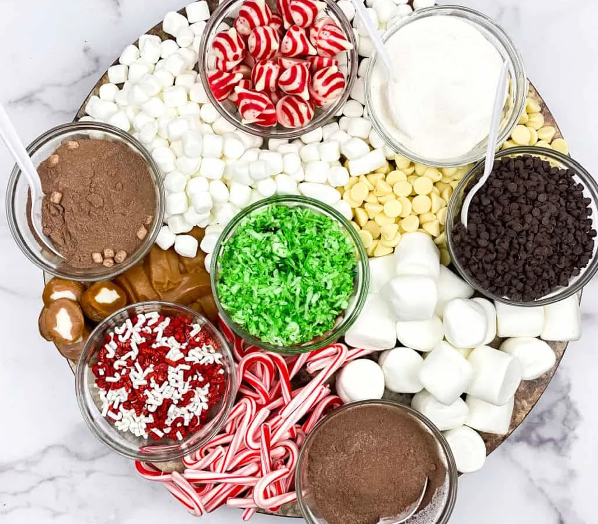 Merry about town's simple cocoa charcuterie board with chocolate chips, cocoa mix, and many more toppings.