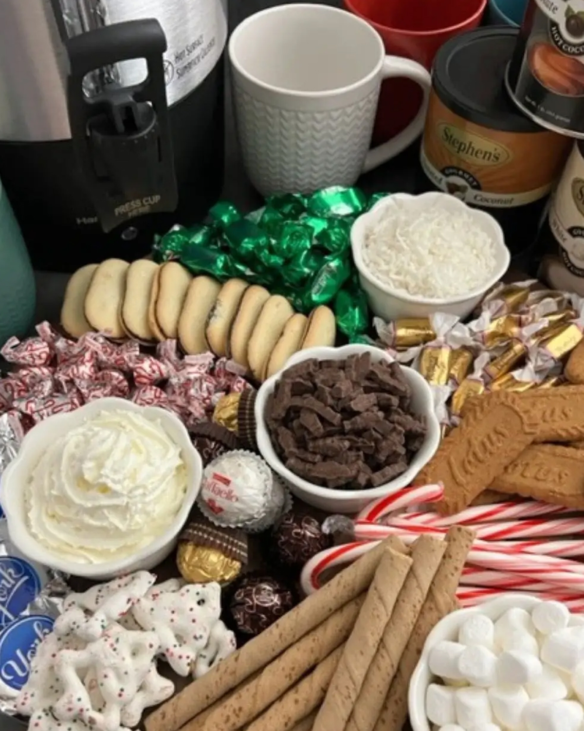 a cookie filled board with whipped cream, chocolate chunks, caramels, and more from sweeter with sugar.