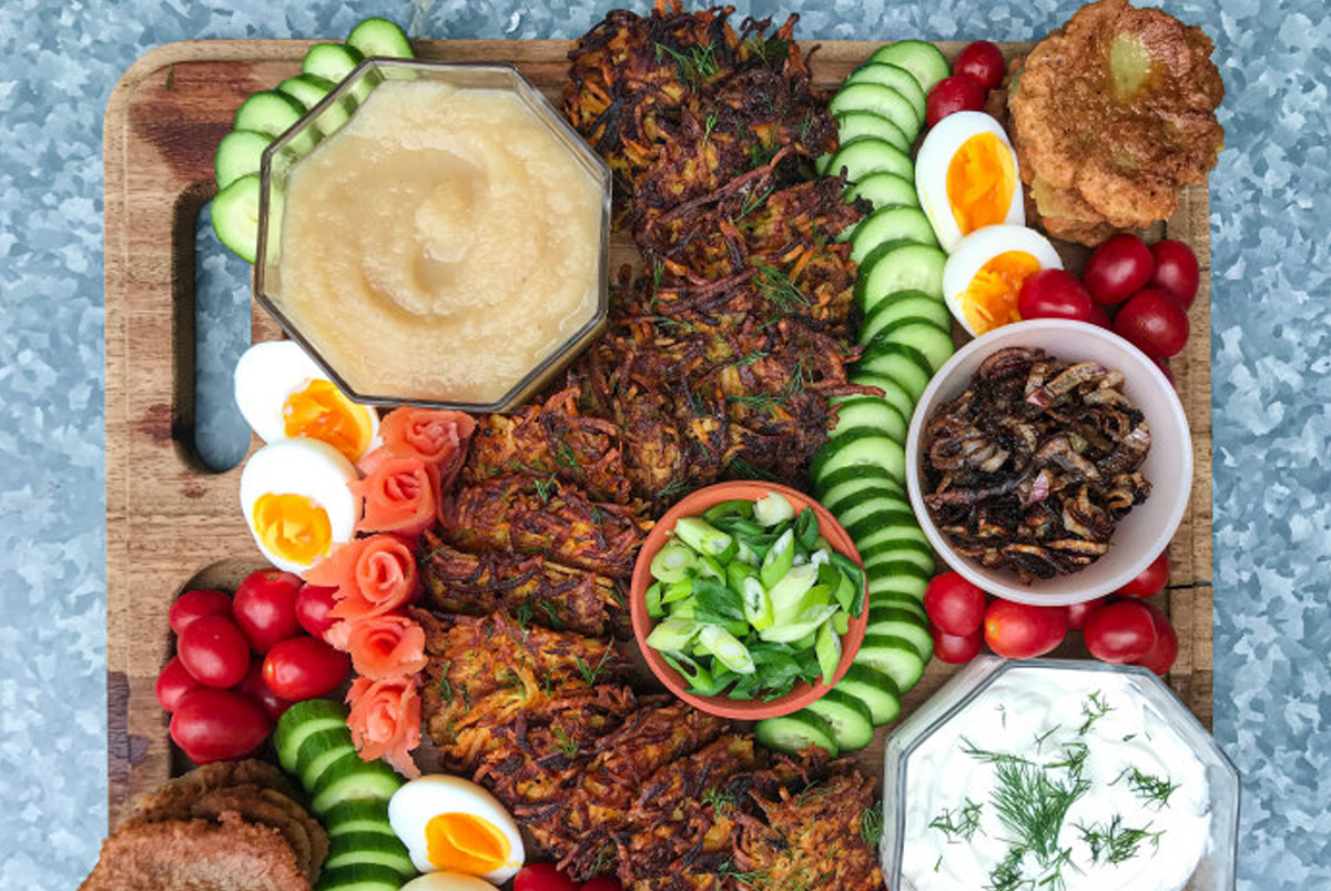 tomatoes, appel sauce, cucumbers, salmon, latkes, and more make up this delicious make your own charcuterie board from Reformjudaism.org