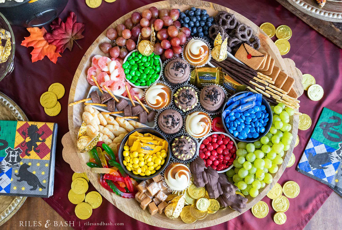 Gummy worms, grapes, m&m's, chocolate frogs, and candy brooms fills Riles and Bash's Harry Potter themed charcuterie board.