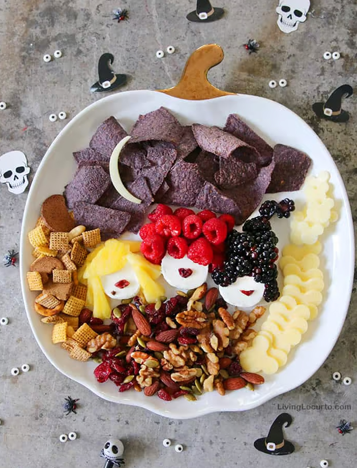 Living Locurto's Halloween board is filled with chips, berries, cheese, nuts, and chex mix.
