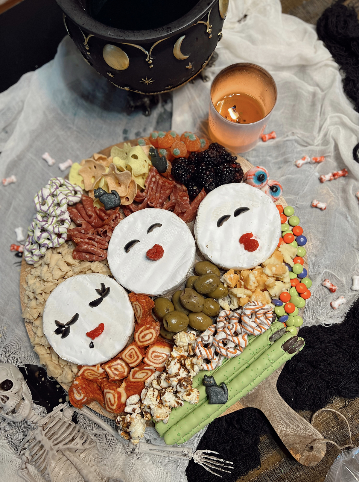 Nashville Wifestyles board is complete with berries, meats, cheese, olives, candy, and chips.