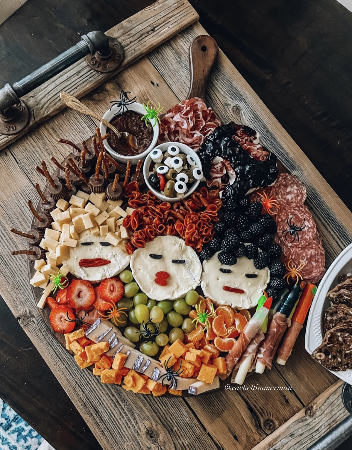 Something Delightful's board showcases meats, berries, cheese, grapes, strawberries, and candy.