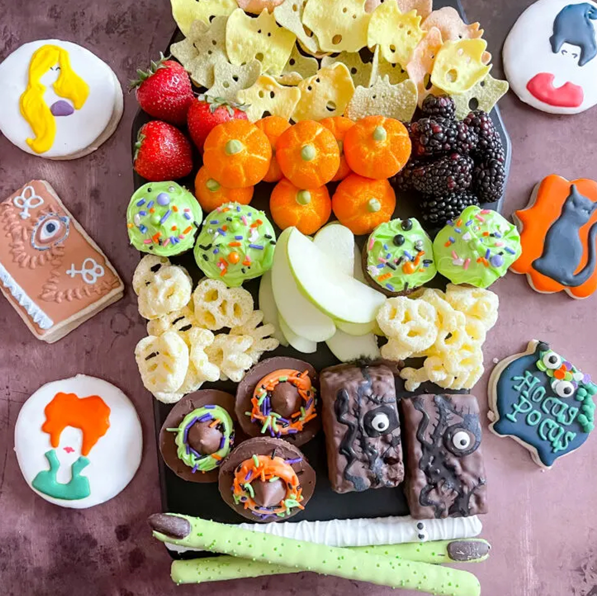 Berries, festive cookies, apples, skeleton chips, and sweet treats fill The Denver Housewife's charcuterie board.