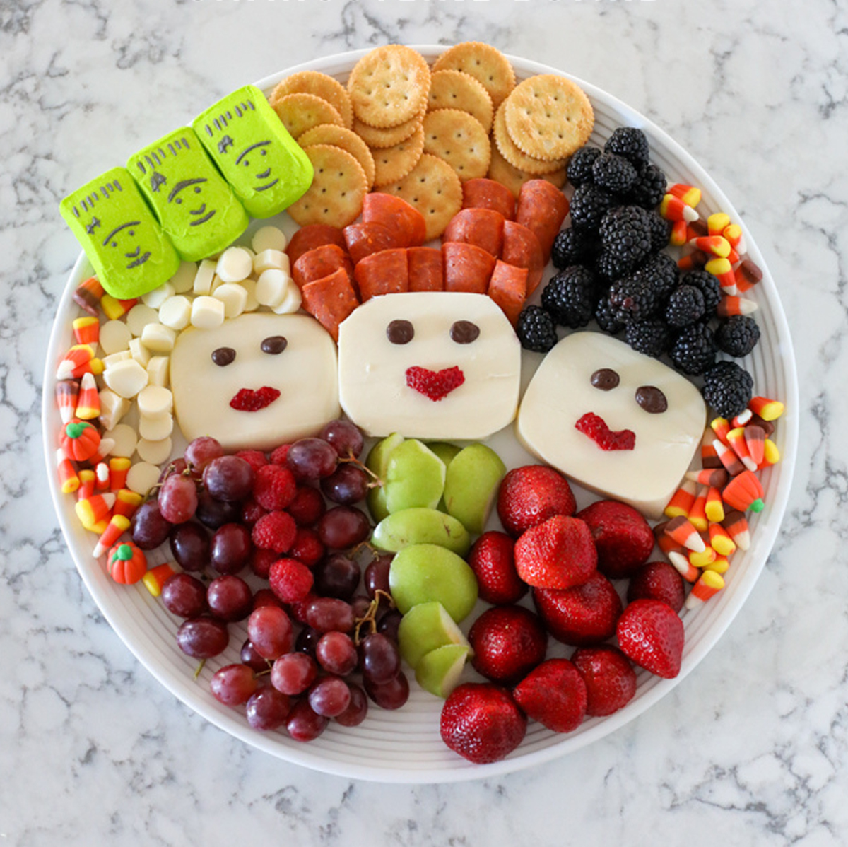 Cheese, crackers, berries, meats, candy corn, and grapes are included on Viva Veltoro's charcuterie board.