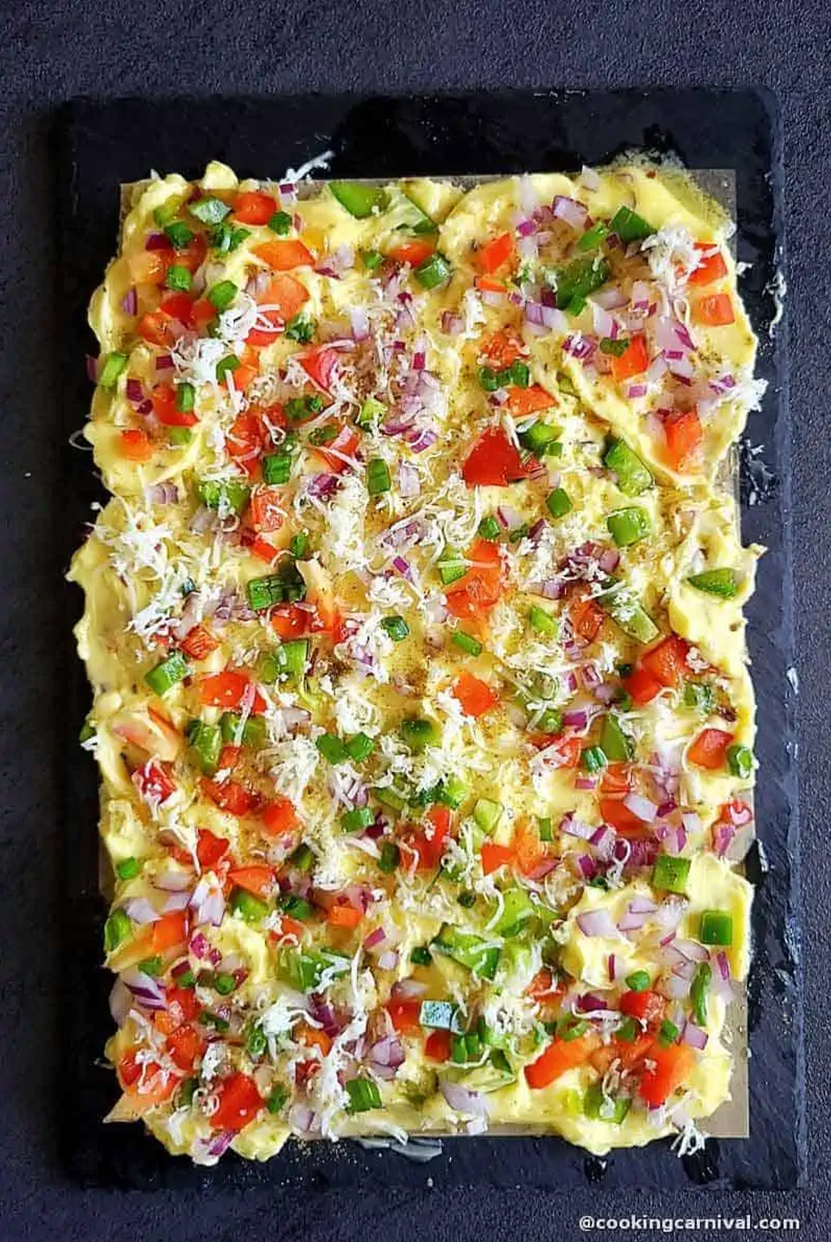 A butter board willed with herbs and veggies with naan is shown on Cooking Carnival's Butter Board.