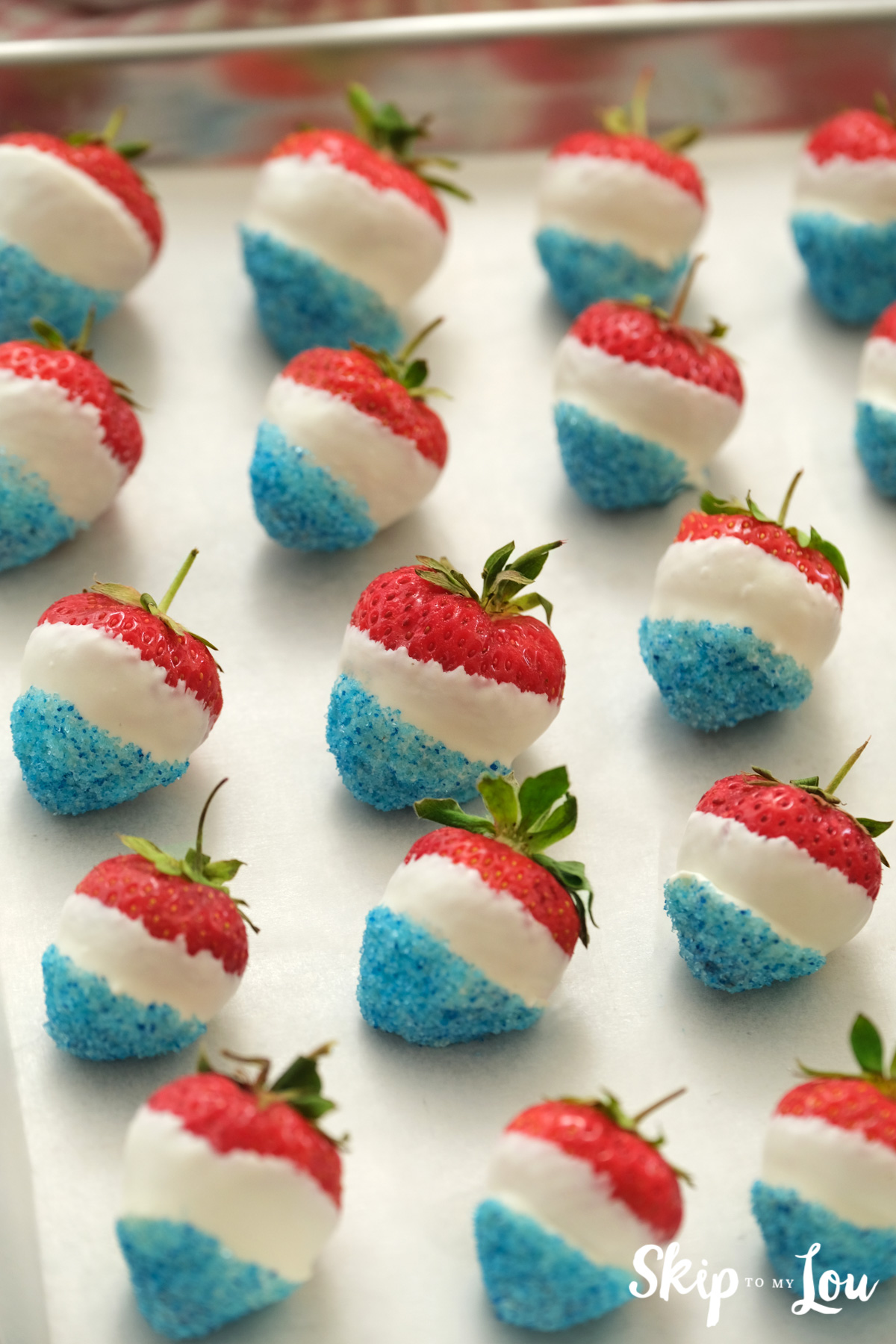 red white and blue strawberries on sheet pan
