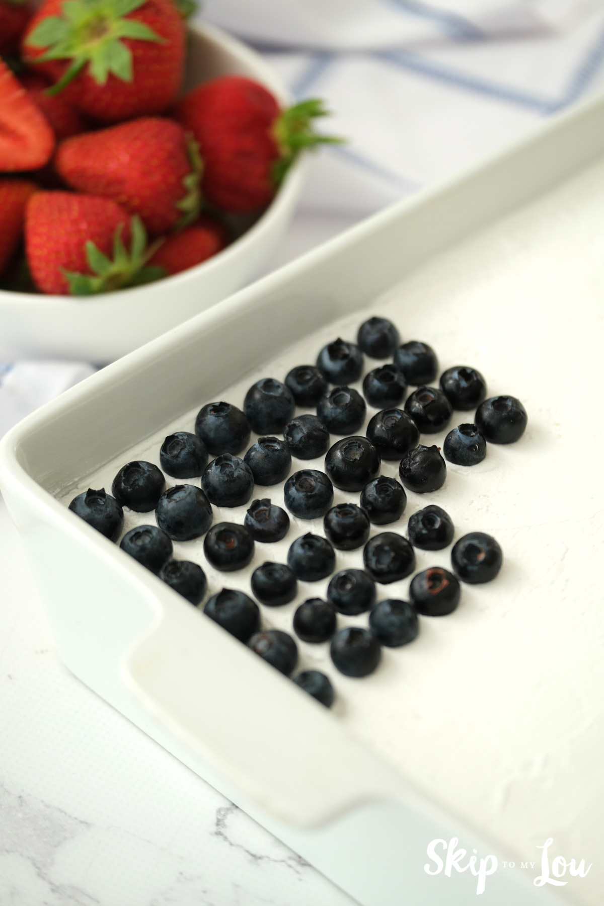 blue berries and strawberries to make cake look like flag