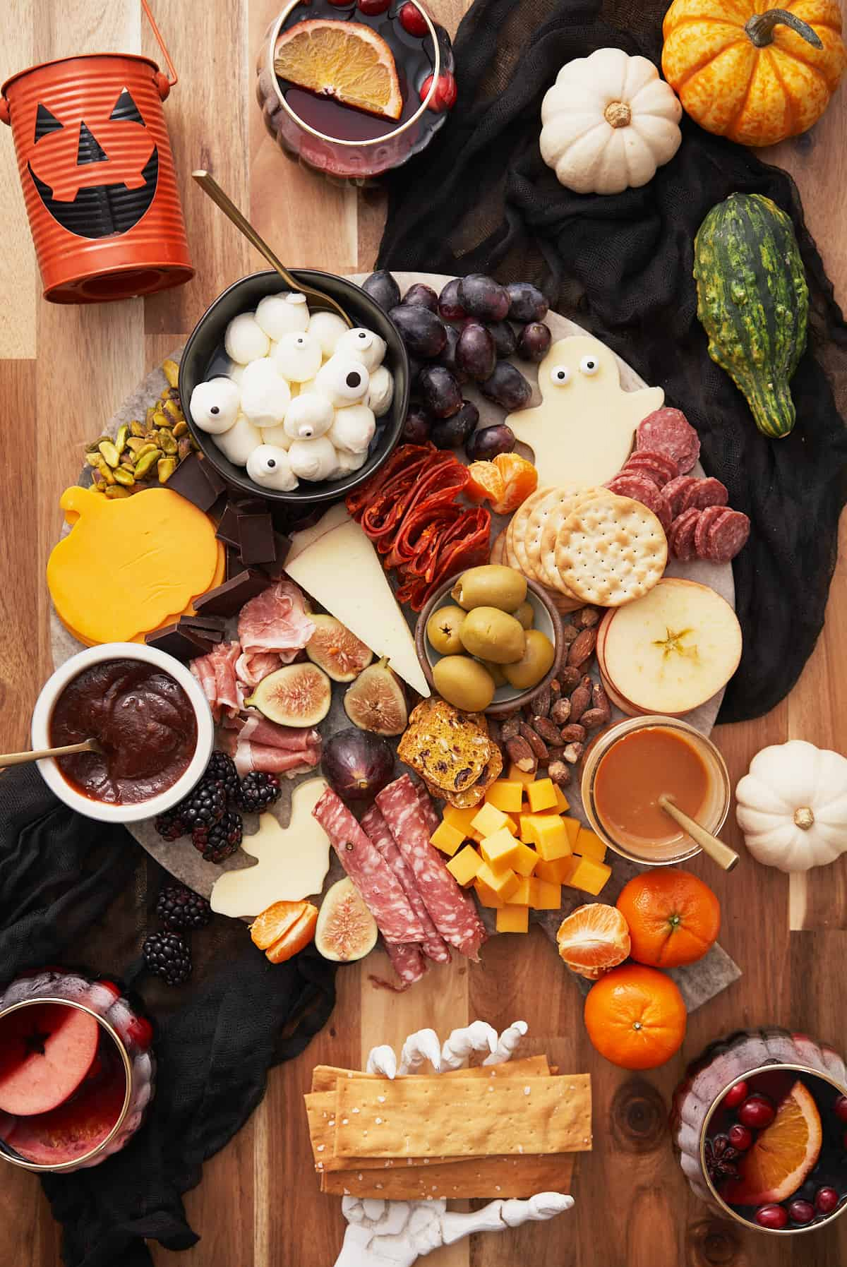 A Full Living charcuterie board showcases meats, cheeses, grapes, olives, and nuts.