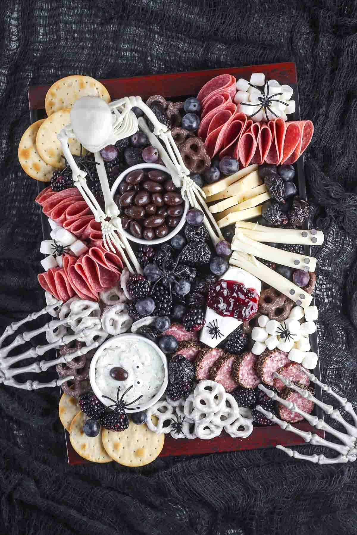 Meats, chocolate-dipped pretzels, cheese, fruit, and crackers fills Aleka's Get-Together Halloween board.