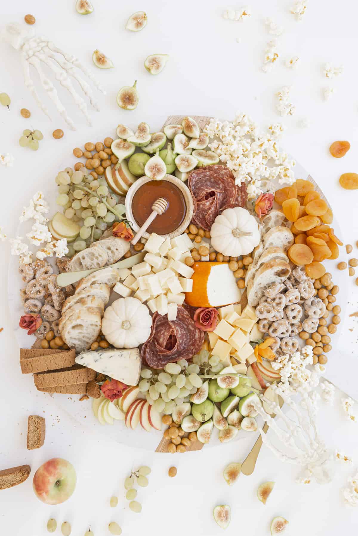 Amanda Wilens charcuterie board includes fruit, cheese, meats, bread, and popcorn.