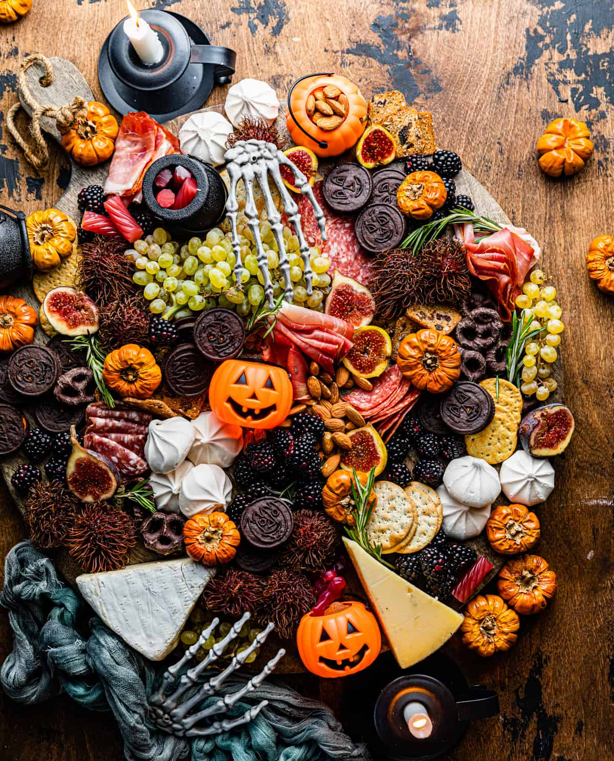 Britney Breaks Bread's Spooky board is filled with cookies, grapes, berries, meats, nuts, and crackers.