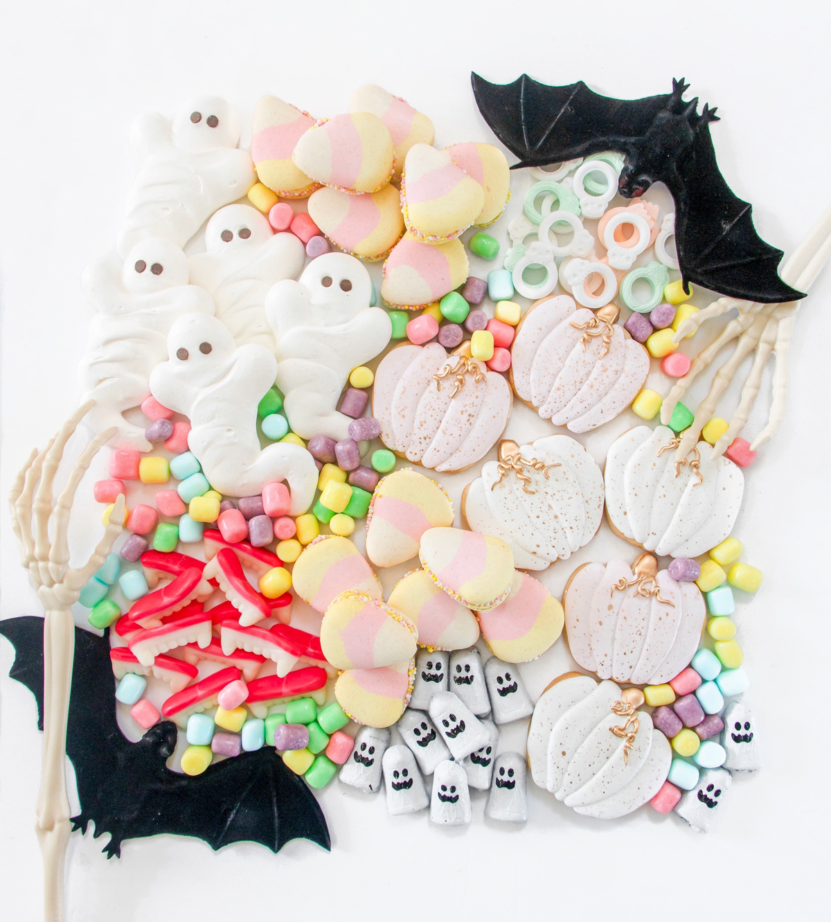 Chandeliers and Champagne's Pastel board showcases pastel-themed sweets like cookies and candy.