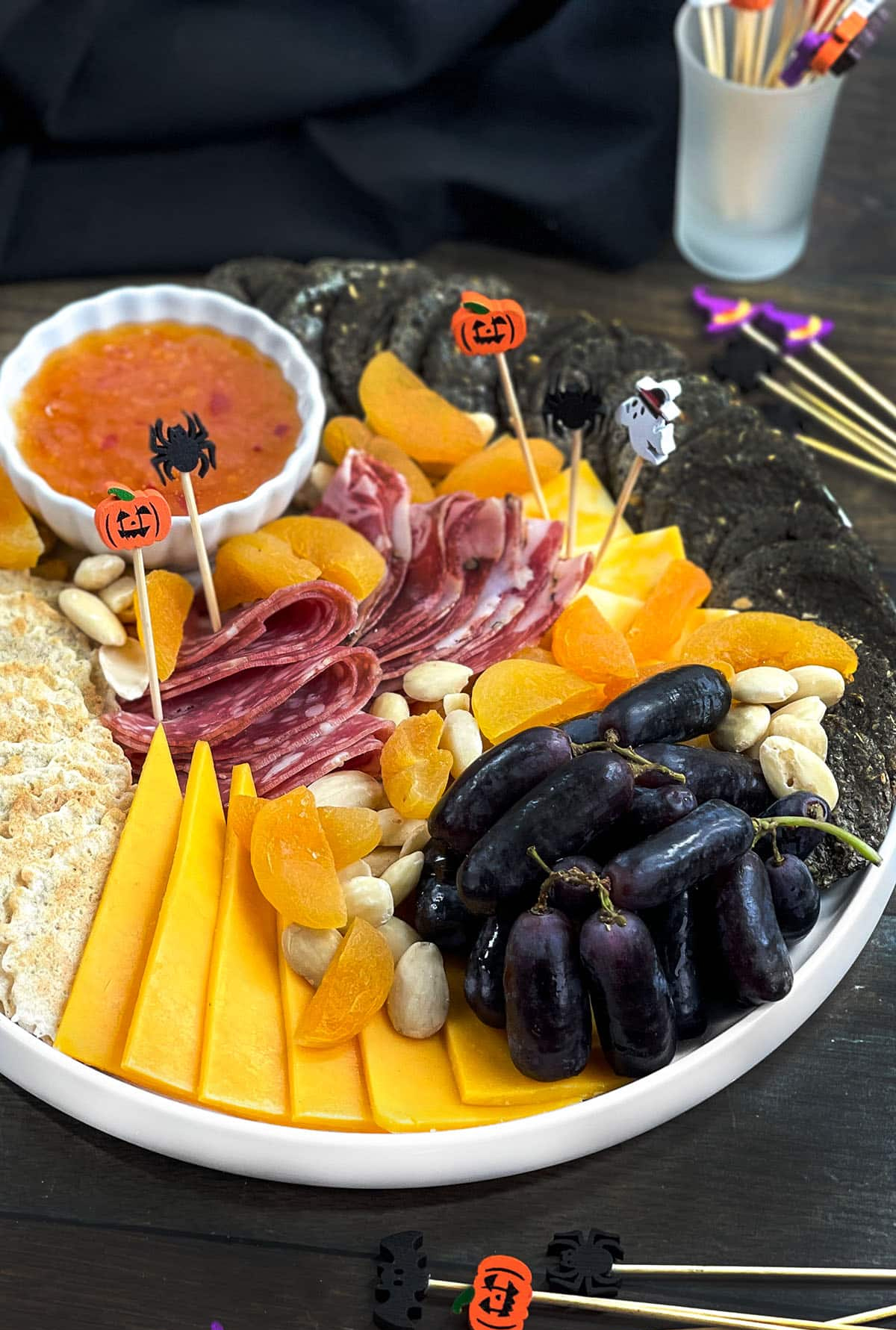 Cheeses, meats, nuts, and grapes fills Cook the Story's Halloween board.