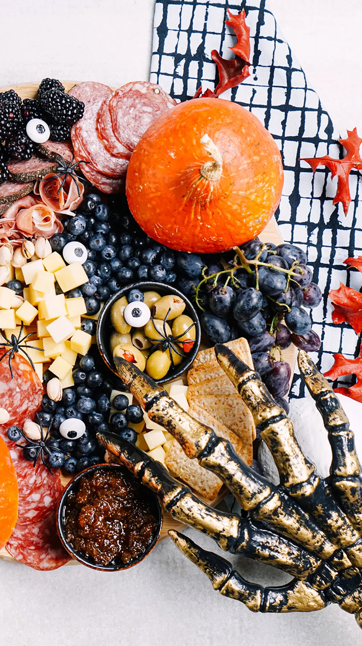 Cozymeal's board is filled with meats, fruits, cheese, and crackers.