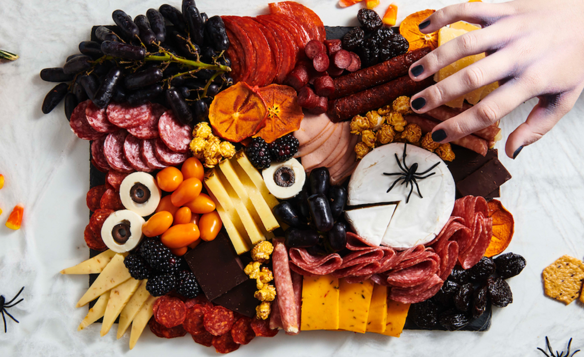 A variety of cheese, meats, olive eyeballs, and fruit fill Dietz & Watson Spooky Charcuterie board.