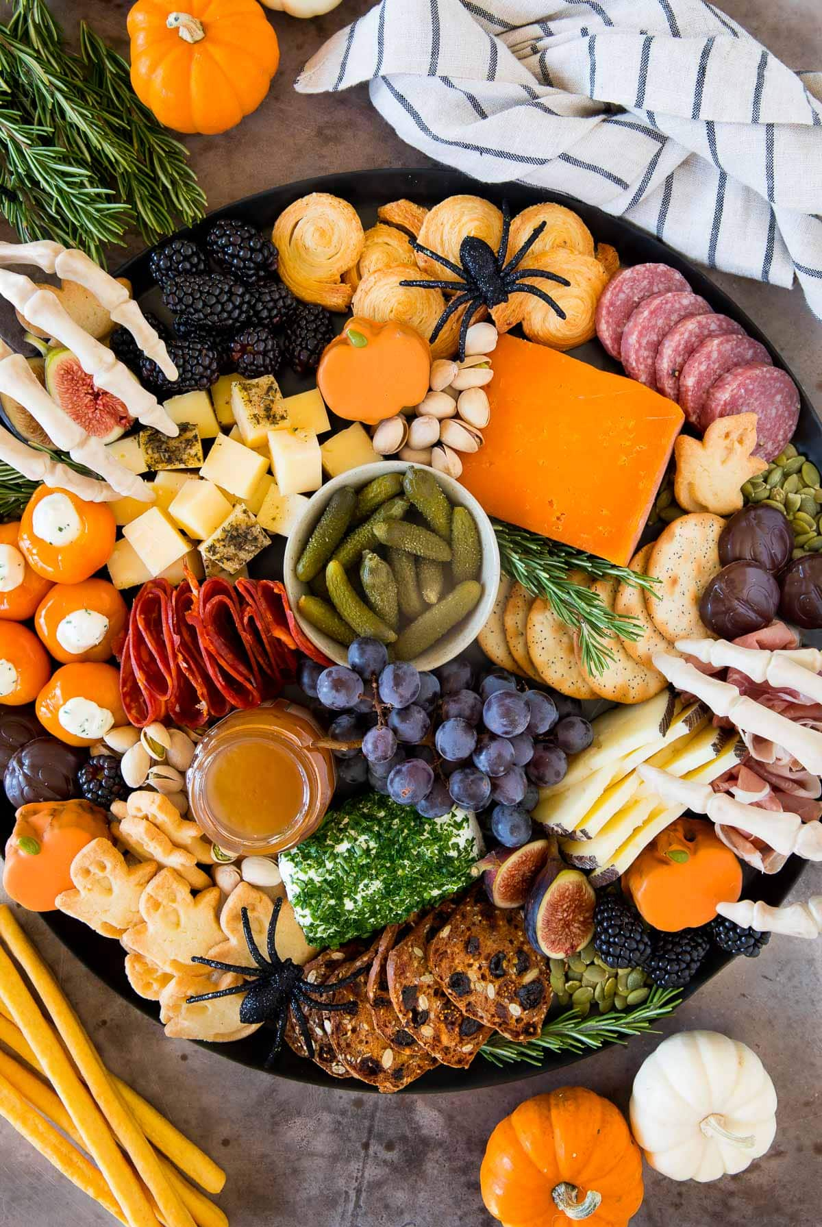 Meats, cheese, pickles, grapes, cookies, and chocolate are included on Dinner at the Zoo's Halloween board.