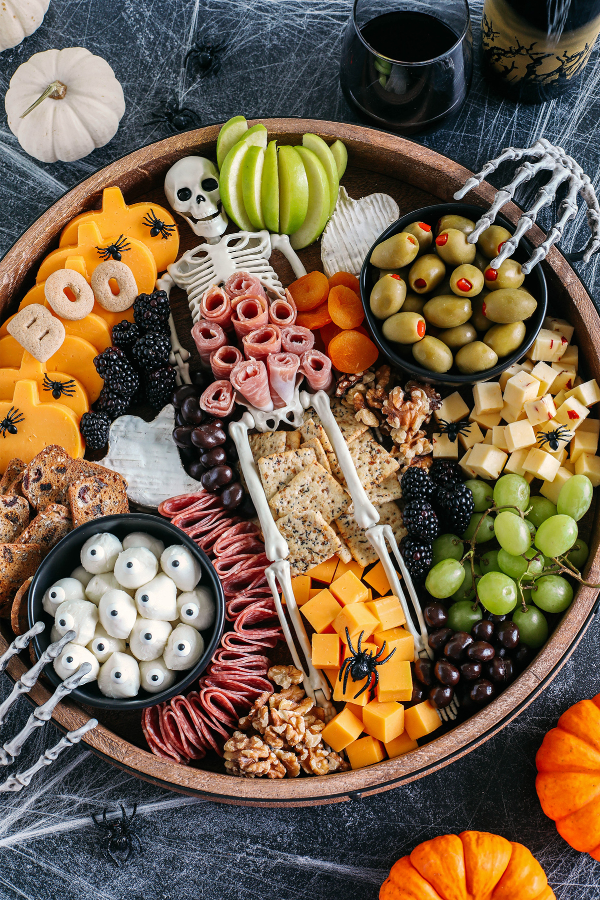 Eat Yourself Skinny's Halloween Board includes, olives, cheese, apples, fruit, meats, and nuts.