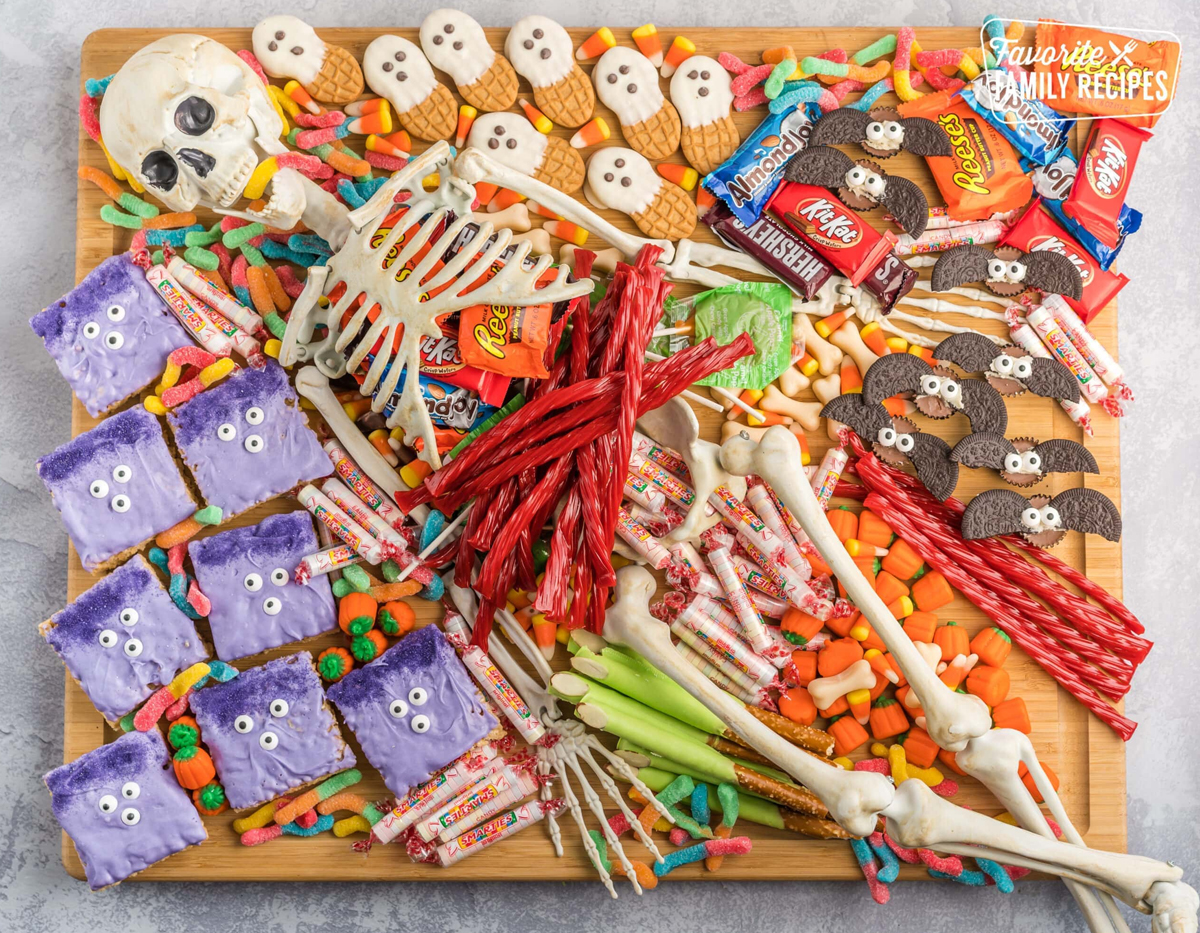 Homemade rice krispies, cookies, and candy fill Fav Family Recipes Halloween Party board.