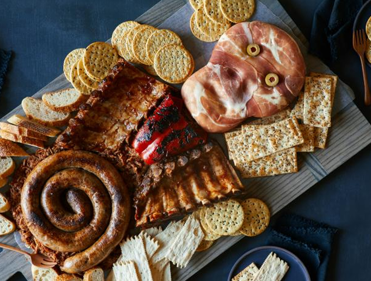 A mix of meat, cheese, and crackers is included on Food Network Kitchen's Skeleton Meat Platter.