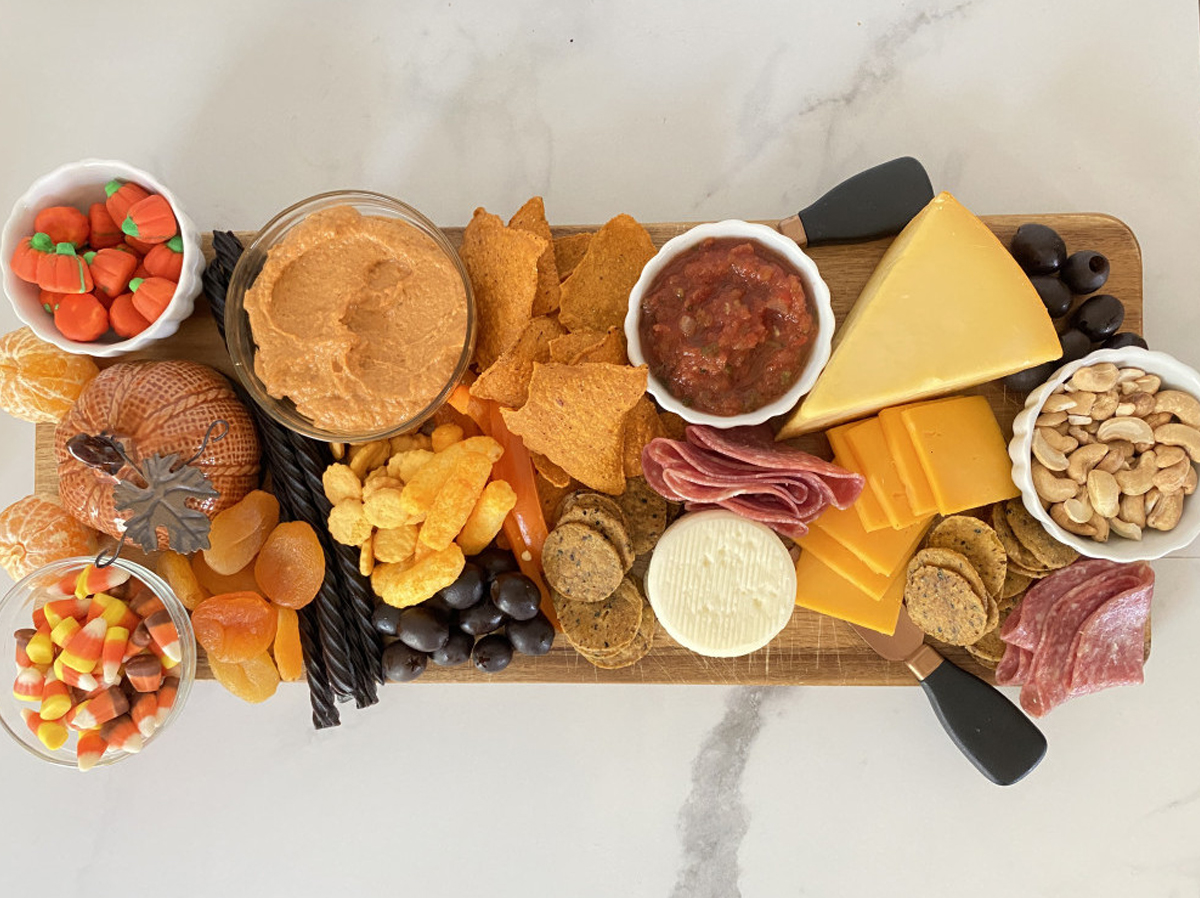 Healthy Foodie Online Halloween board is filled with cheese, meat, candy, crackers, and nuts.