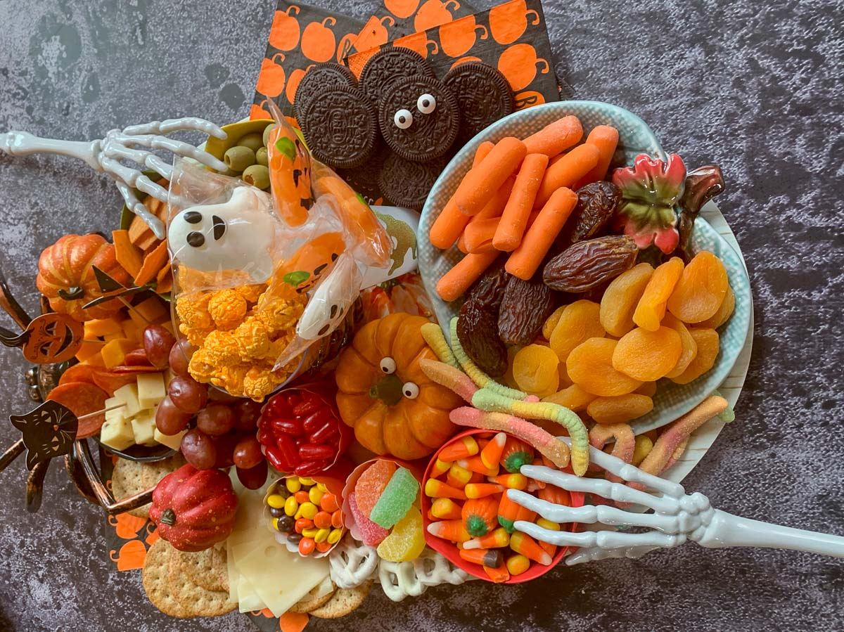 Hilda's Kitchen Blog's Halloween Charcuterie Board showcases veggies, cookies, candy, fruit, and crackers.