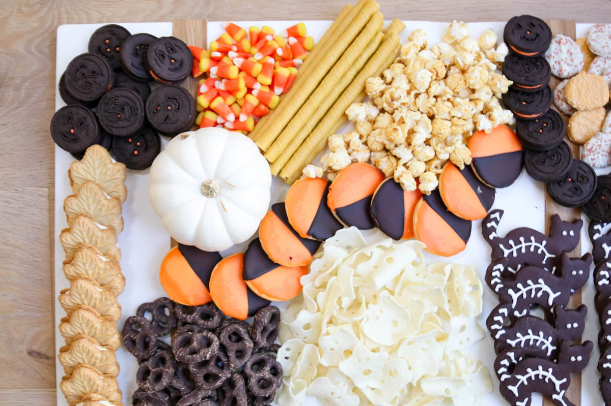 Modern Glam's Halloween Board showcases cookies, candy, popcorn, and candy corn.