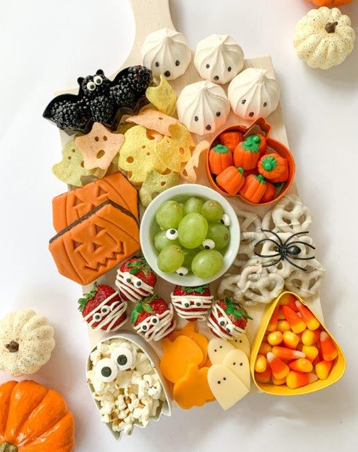 Party Pinching serves up a Halloween Charcuterie board with candy corn pumpkins, pretzels, grapes, and cookies.