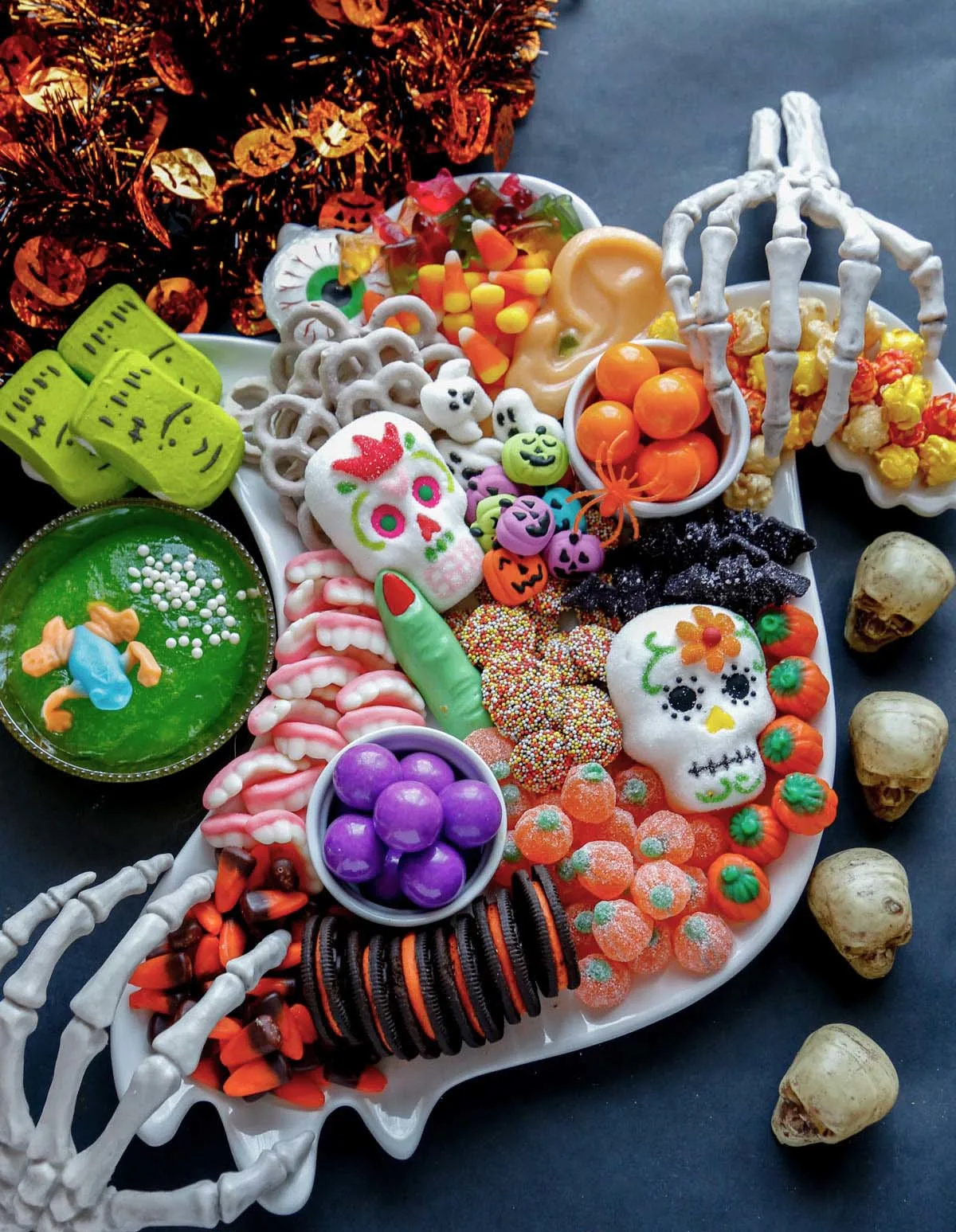 Candy, popcorn, and gummies fill Pint-Sized Baker's Halloween candy board.