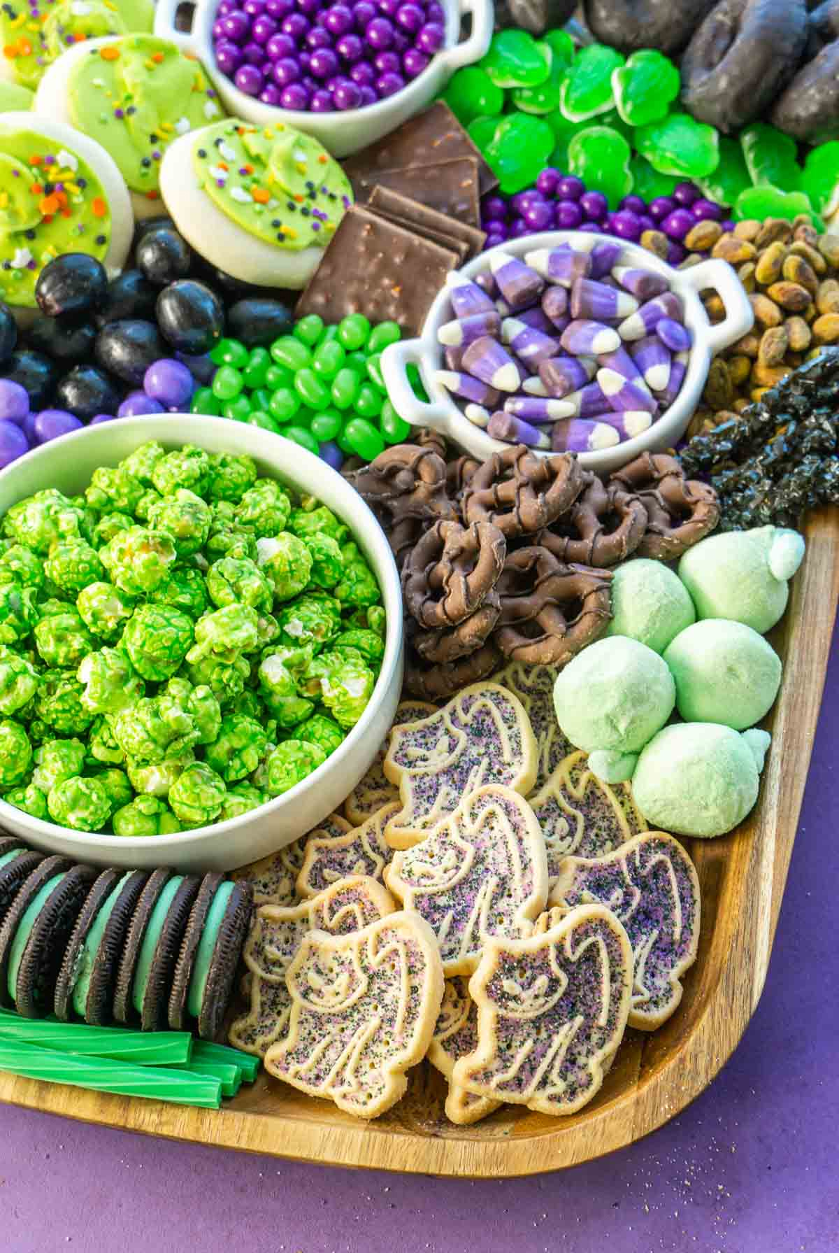 Play Party Plan's Halloween Dessert board is filled with candy, chocolate, cookies, and donuts.