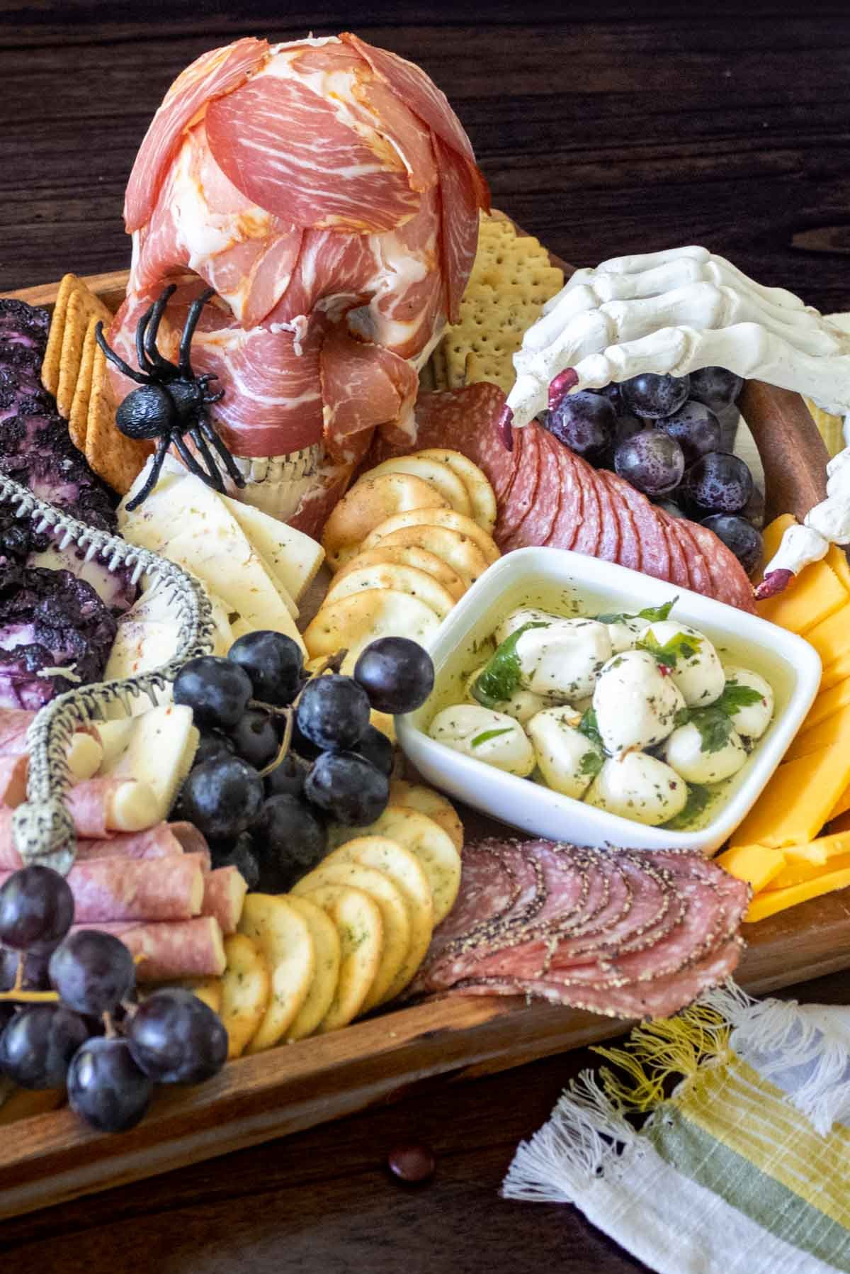 A Simply Scrumptious Eats fills their Halloween board with mozzarella balls, meats, cheeses, and crackers.