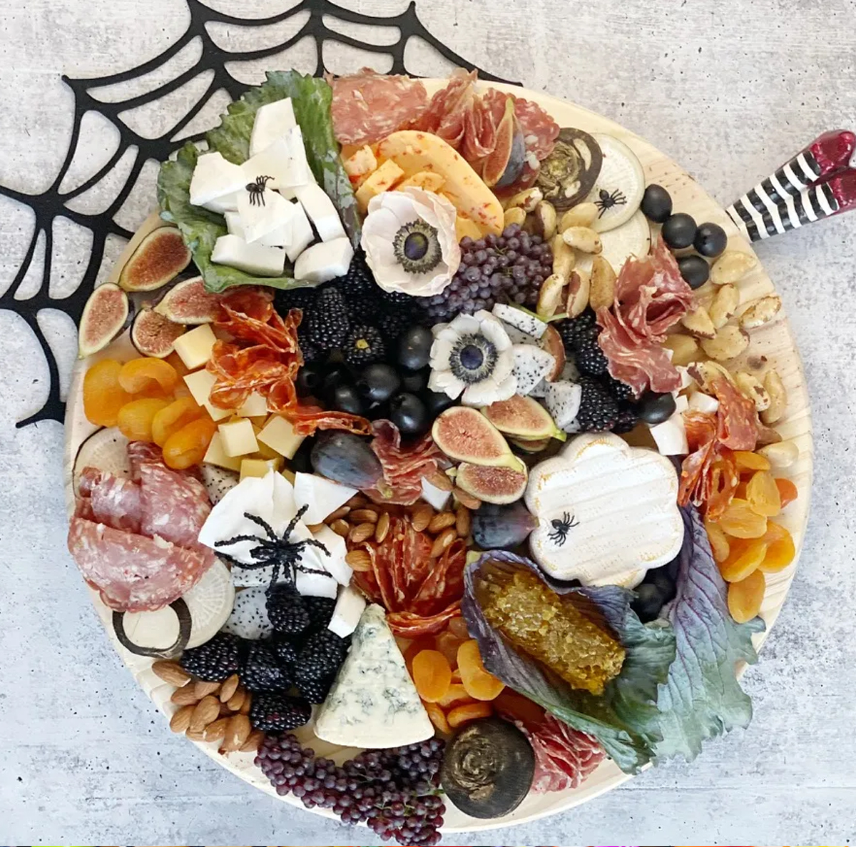 Red pepper gouda, meats, fruit, and nuts are showcased on Sparkling Charm's Halloween Board.