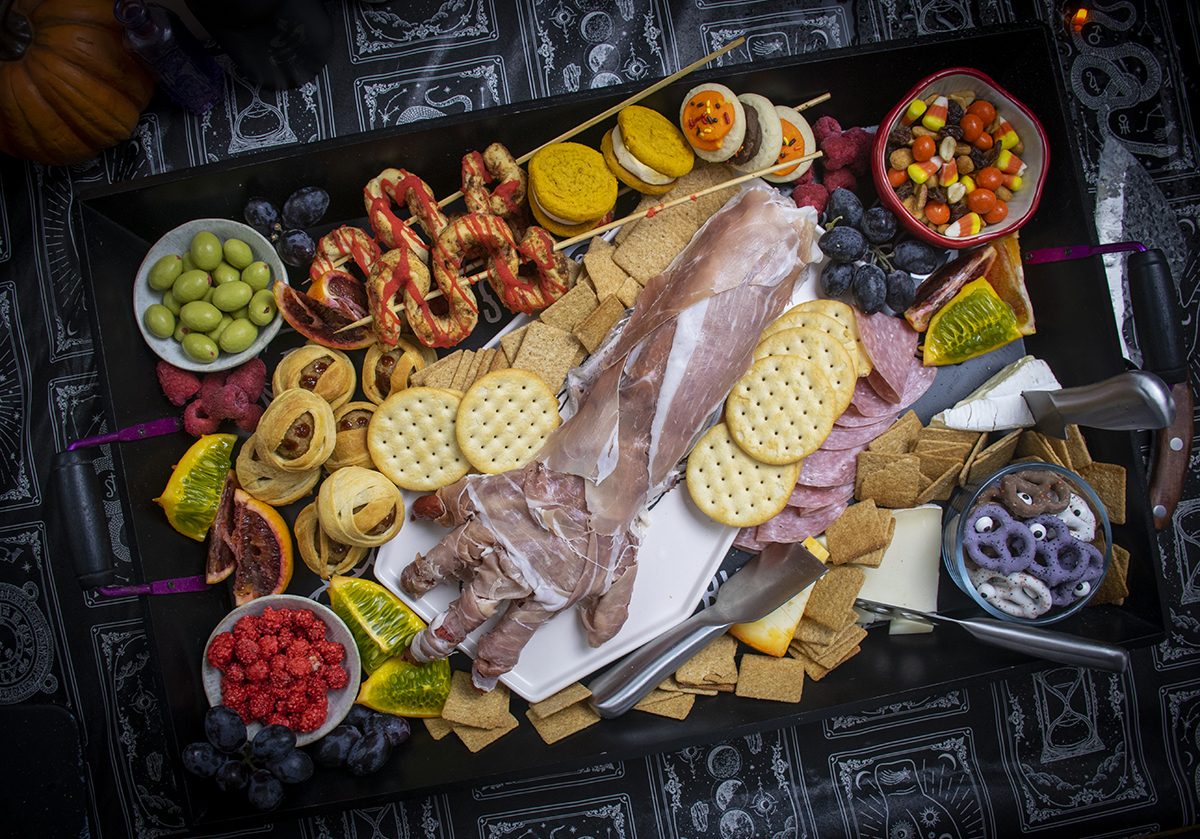 Candy, meats, crackers, olives and cheese is included on The Starving Chef's Halloween board.