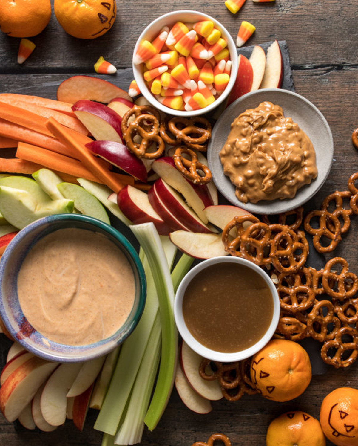 Washington Apple Commission's Halloween board showcases candy corn, dips, apples, carrots, and pretzels.