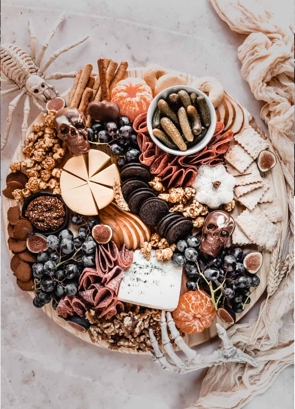 Windy City Dinner Fairy's Halloween board includes popcorn, cookies, meat, cheese, crackers, and pickles.