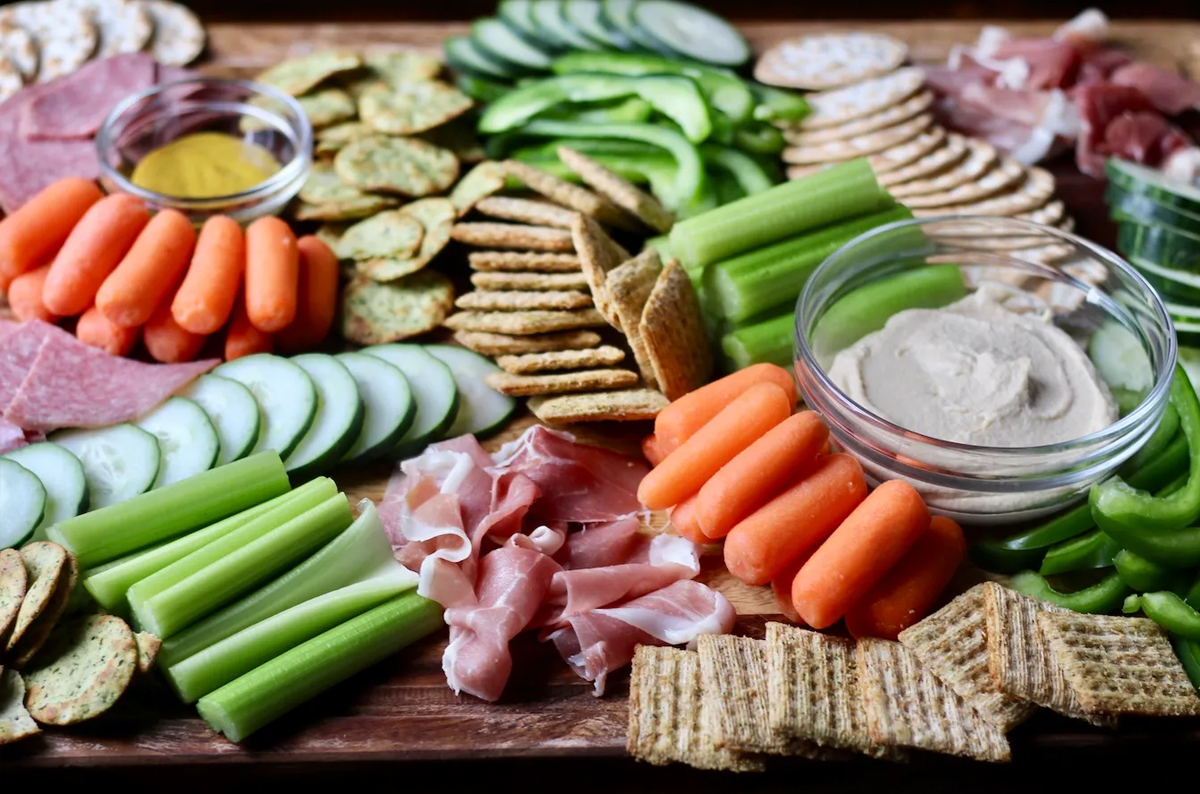 Life After Dairy's board showcases dips, celery, carrots, meats, crackers, and peppers.