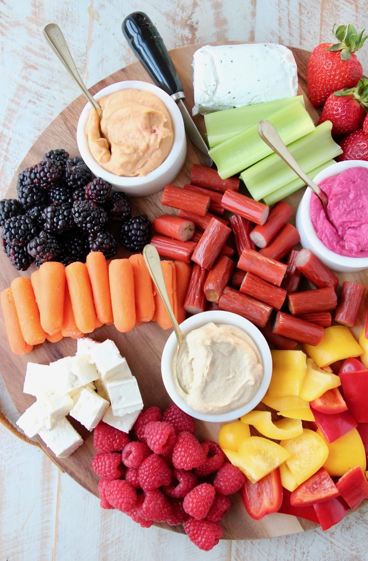Strawberries, spreads, celery, berries, and carrots are showcased on Whitney Bonds board.