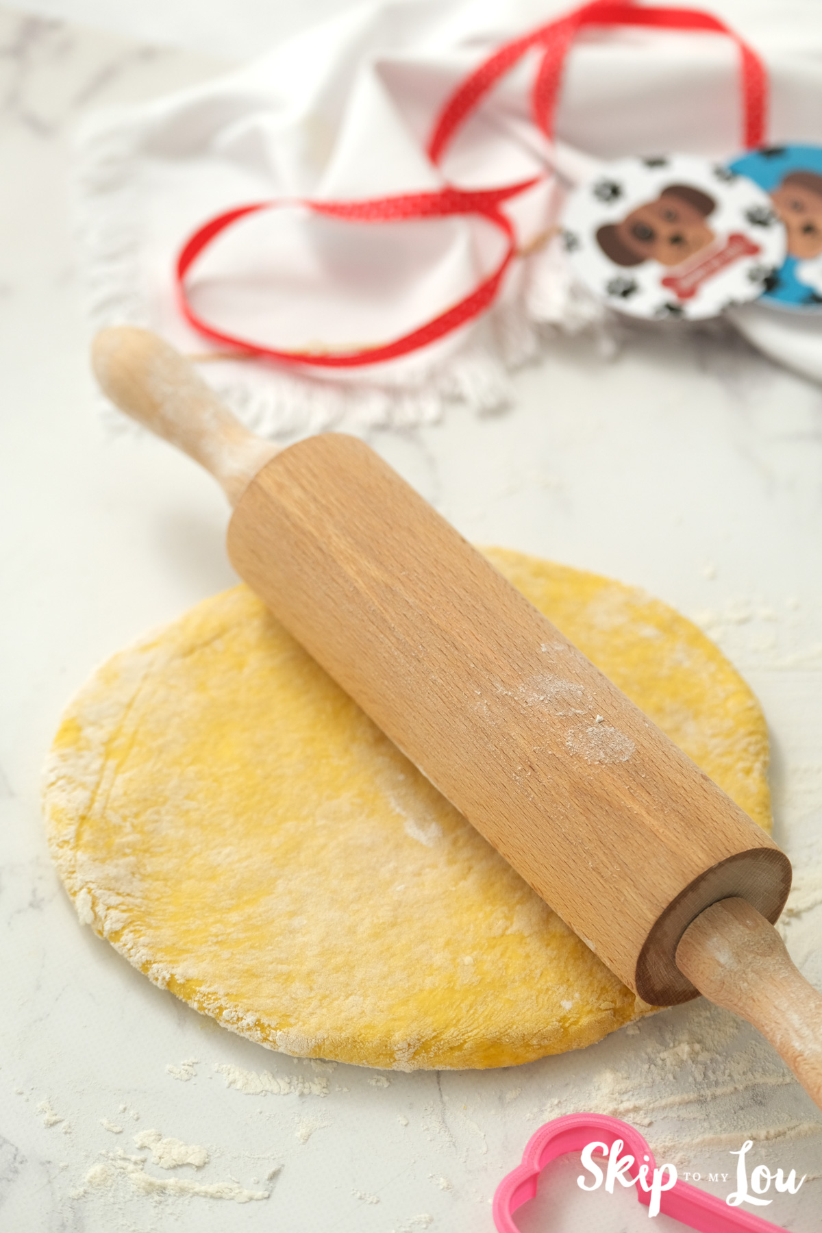 Flattened dog biscuit dough and a rolling pin, by Skip to my Lou.