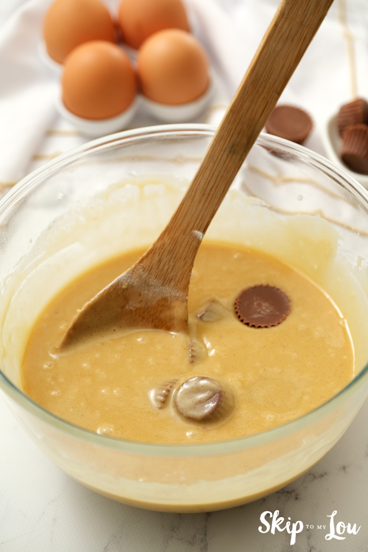 Blondie batter with mini-Reece's cups floating on top, by Skip to my Lou.