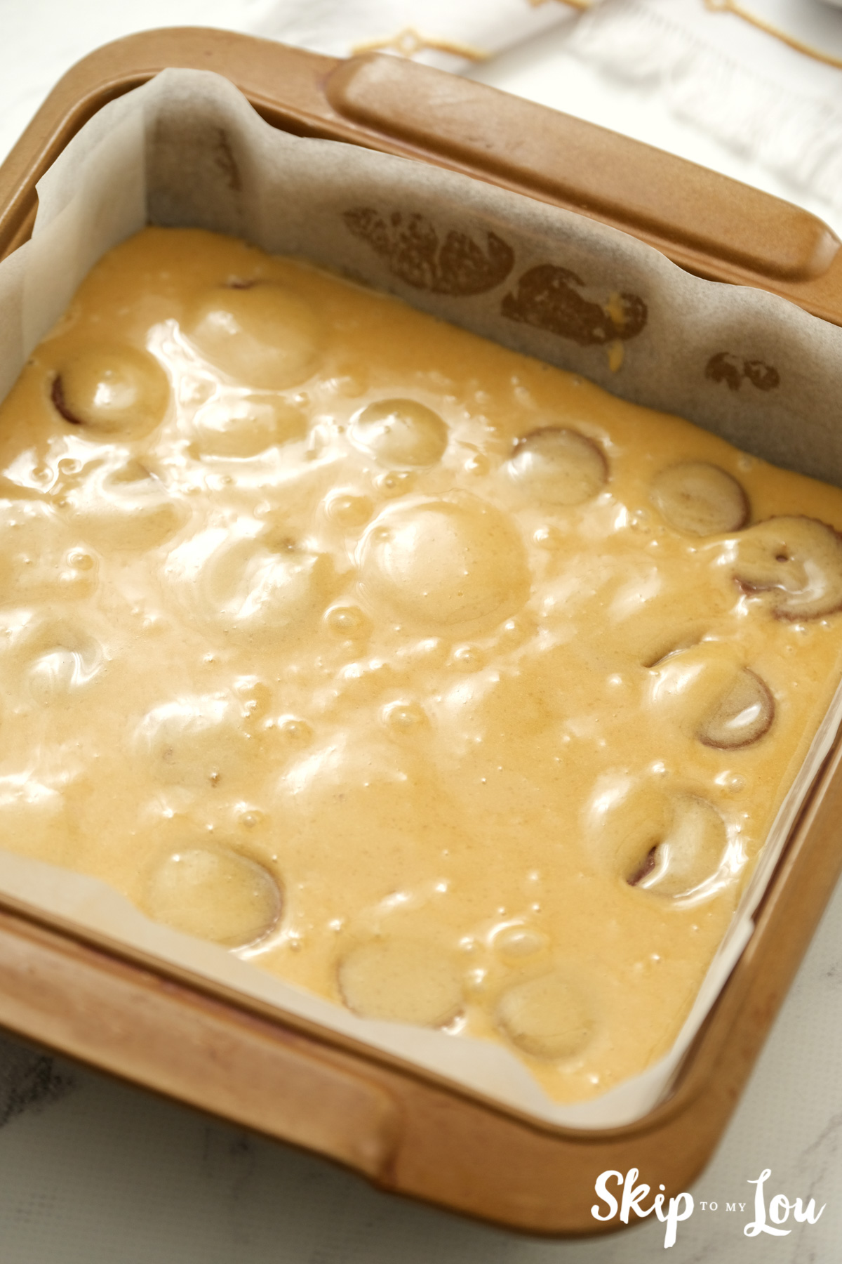 Blondie batter in an 8"x8" inch glass baking dish, by Skip to my Lou.