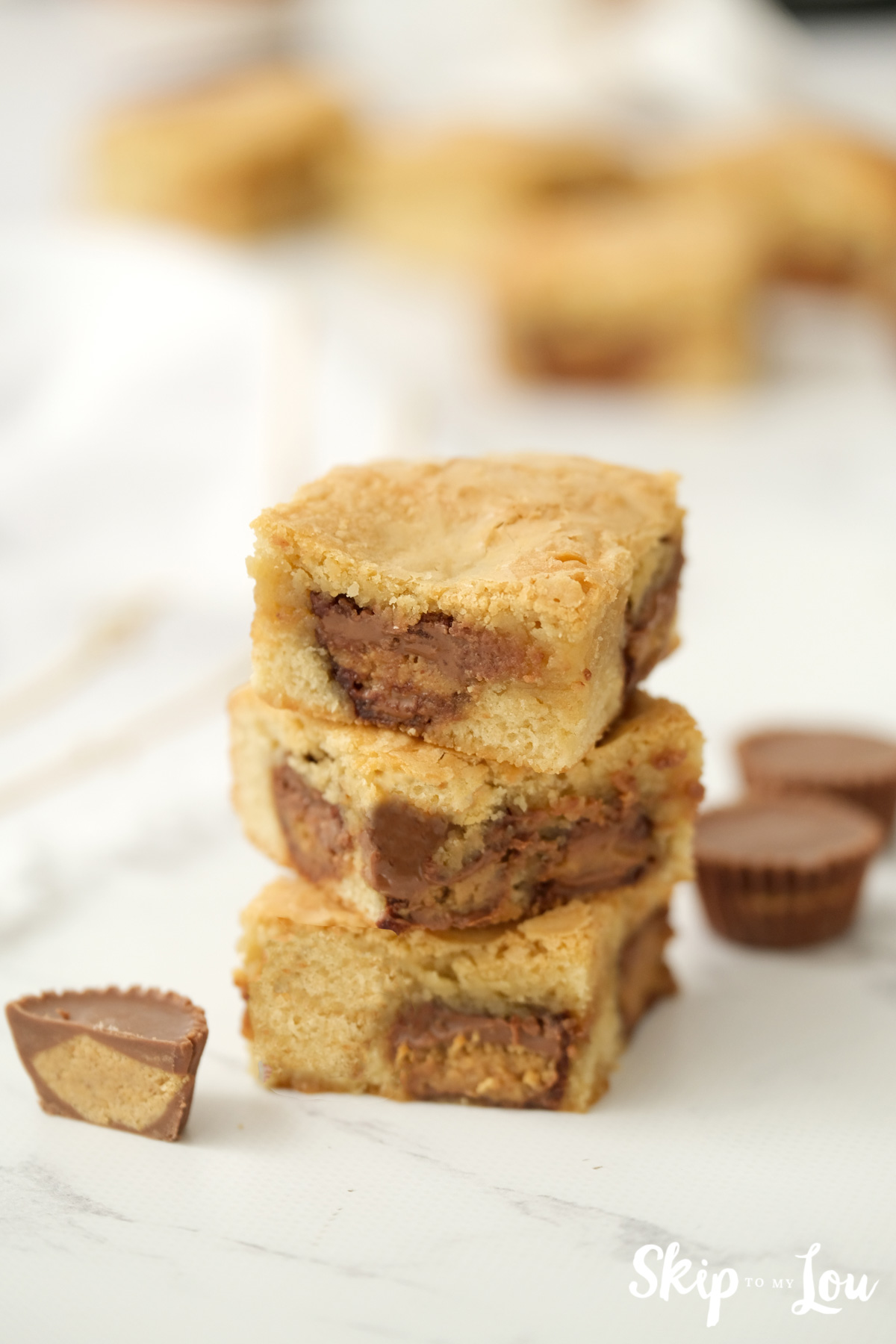 3 Peanut Butter Blondies stacked up and ready to eat, by Skip to my Lou.