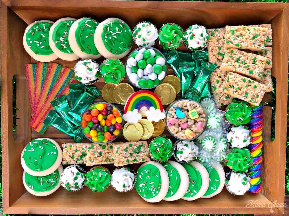 a sweet and dessert board with cookies, cupcakes, candies, and more from Mama cheaps.
