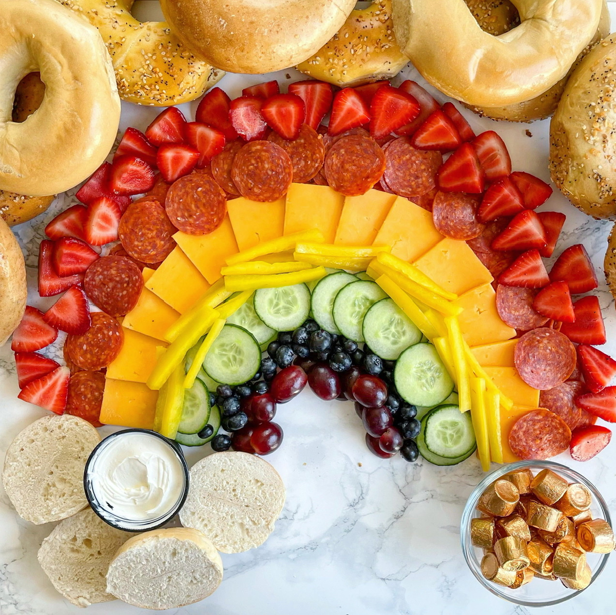 A mix of brunch and sweets with bagels, cheese, pepperoni, fruits, and more from spinach and bacon.