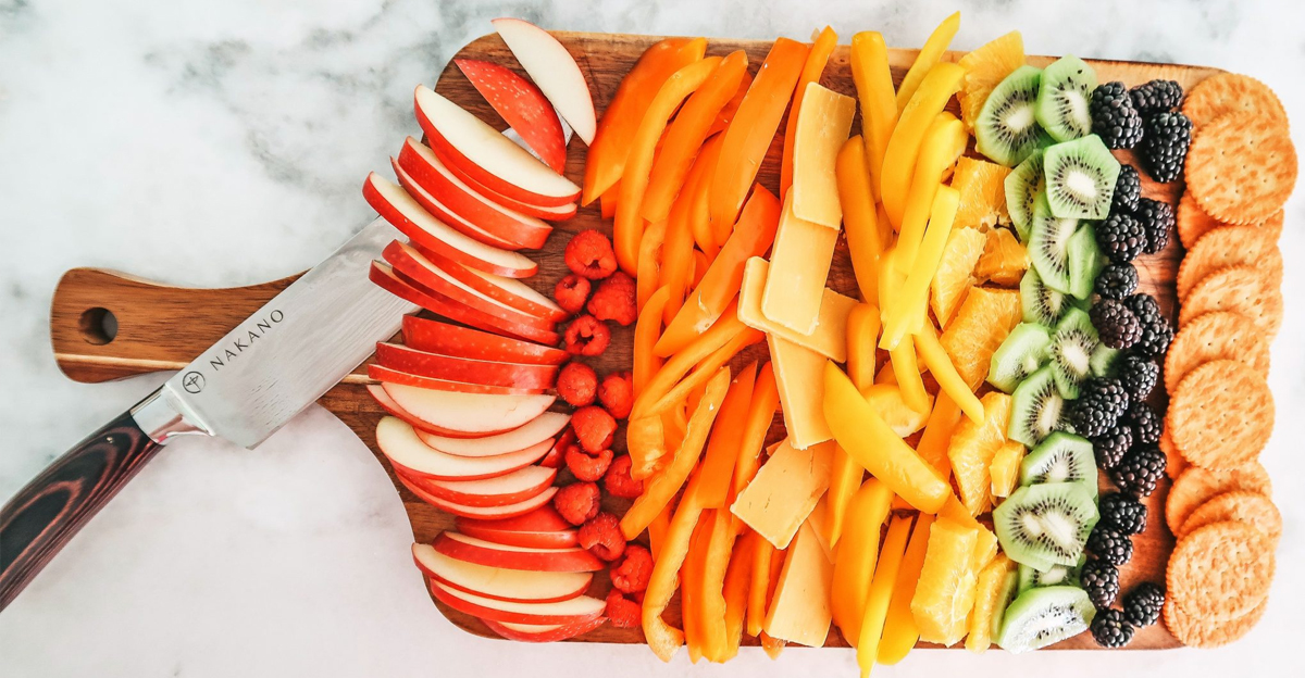 A square board from the southerly magnolia with fruits, veggies, cheese, and crackers.