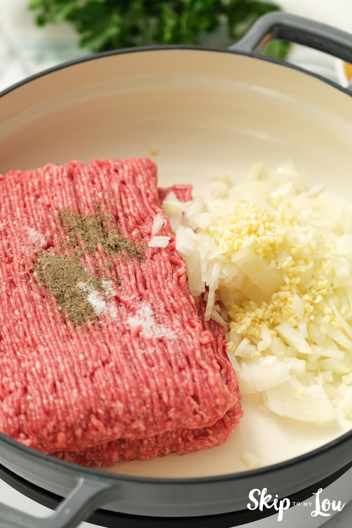 Ground beef, onions, and spices in a pan, by Skip to my Lou.